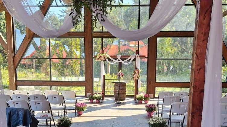 A wedding ceremony setup with floral arch at a venue BillyO worked